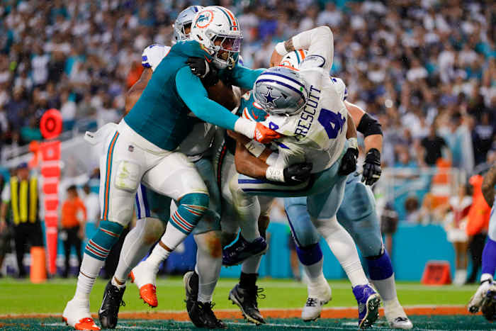 Dolphins defensive tackle Christian Wilkins (94) and linebacker Bradley Chubb (2) tackle Dallas Cowboys quarterback Dak Prescott (4) during the second quarter at Hard Rock Stadium.